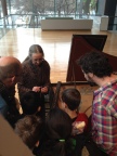 Charlotte Nediger showing students the harpsichord